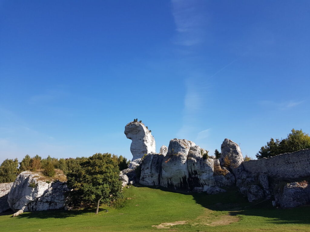 Widok na skały na terenie ruin zamku w Ogrodzieńcu na tle błękitnego nieba 